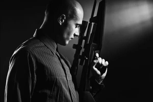 stock image Handsome young man holding a gun