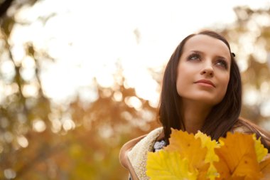 Brunette holding autmun leaves clipart