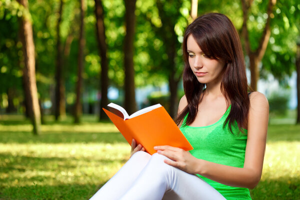 Woman reading book at park