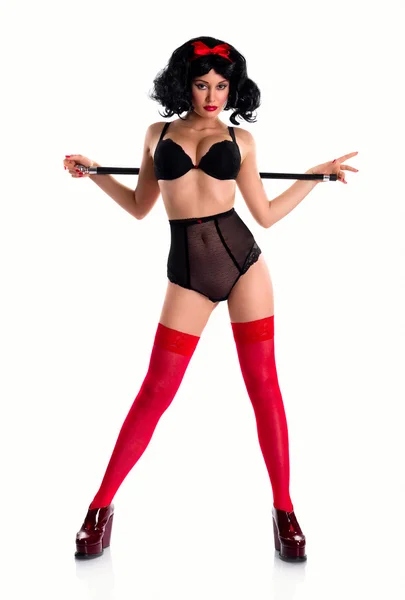 Brincalhão pin-up menina vestindo roupa interior preta e meias vermelhas dentro de casa — Fotografia de Stock