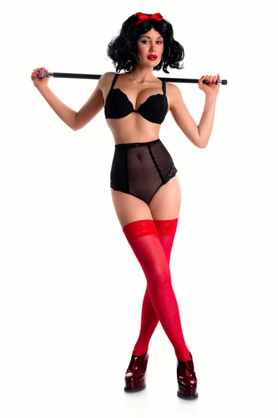 Pin-up girl wearing black underwear and red stockings indoors — Stock Photo, Image