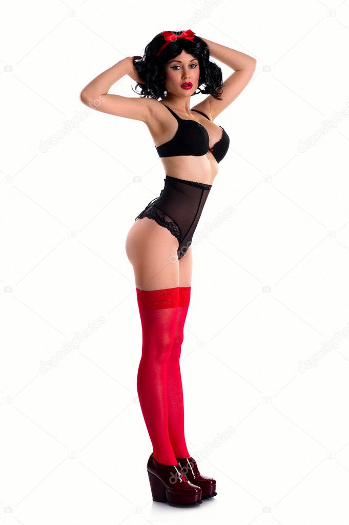 Girl wearing black underwear and red stockings posing indoors