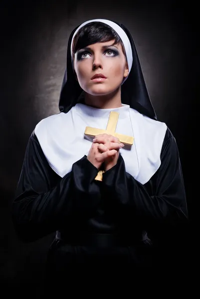 Young attractive nun holding a cross — Stock Photo, Image