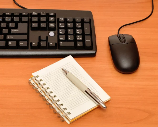 Blank notebook on black keyboard — Stock Photo, Image