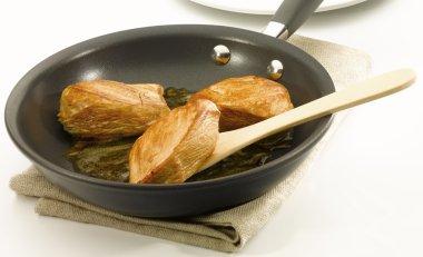 Chicken an a non stick pan clipart