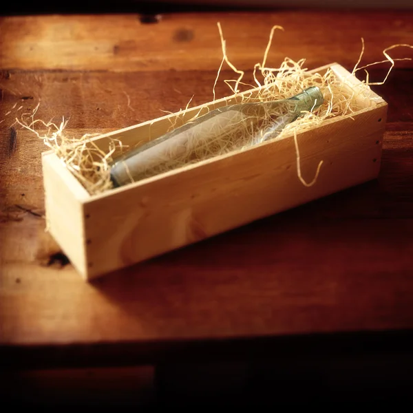 Láhev v dřevěné krabici — Stock fotografie