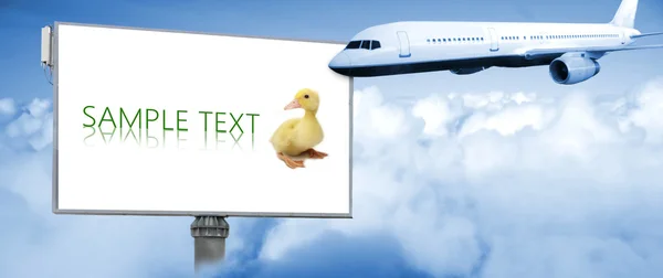 Airplane in the sky with big billboard — Stock Photo, Image
