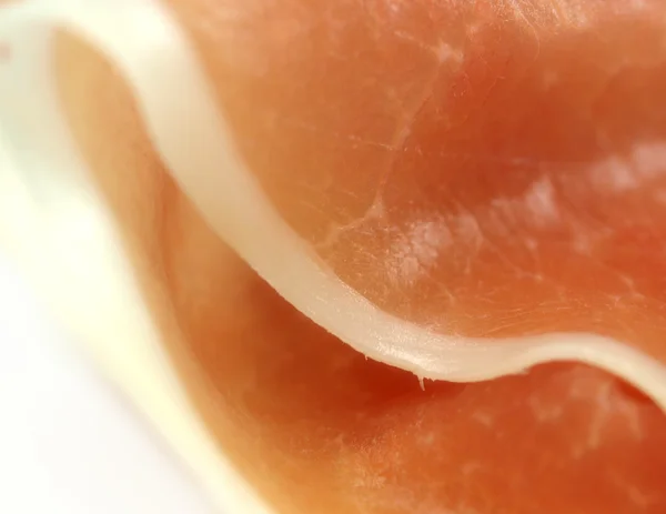 A slice of jamon on white background. — Stock Photo, Image