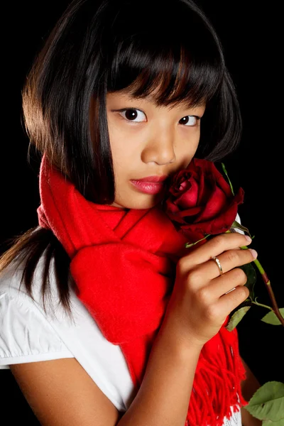 Girl in a red scarf with a rose — Stock Photo, Image