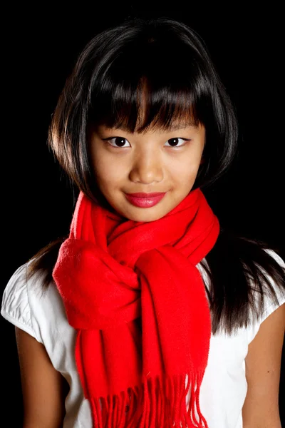 Cute girl in a red scarf — Stock Photo, Image