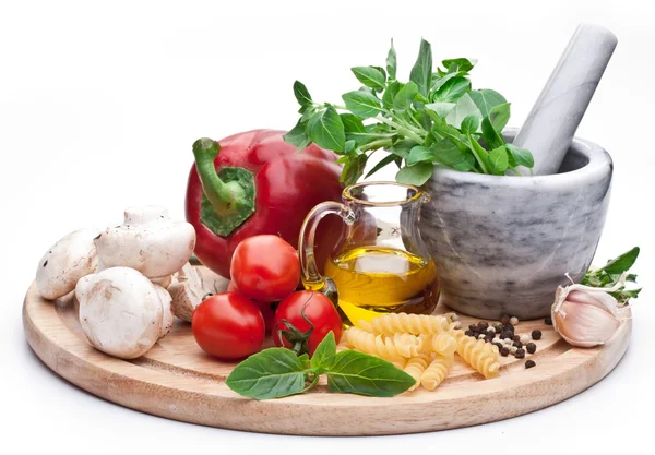 Mortar, herbs and vegetables. — Stock Photo, Image