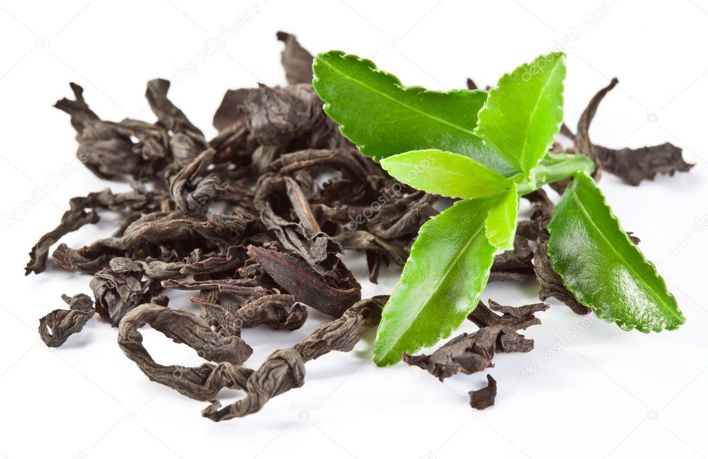 Heap of dry tea with green tea leaves.