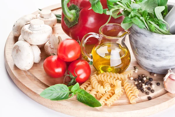 Olivový olej, bylinky a zelenina na stole. — Stock fotografie