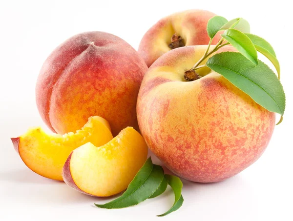 Ripe peach fruit with leaves and slises Stock Photo