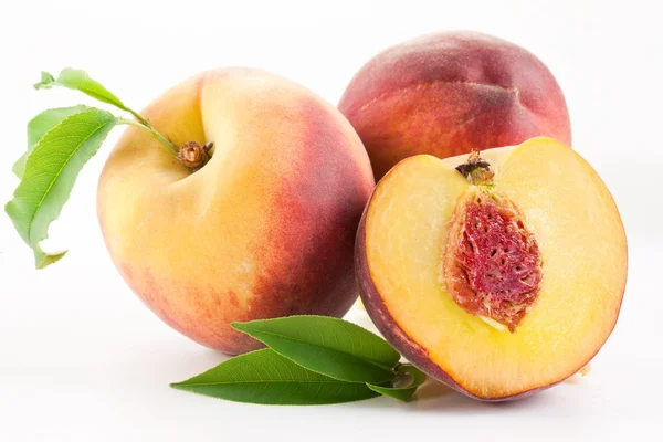 Ripe peach fruit with leaves and slises Stock Photo