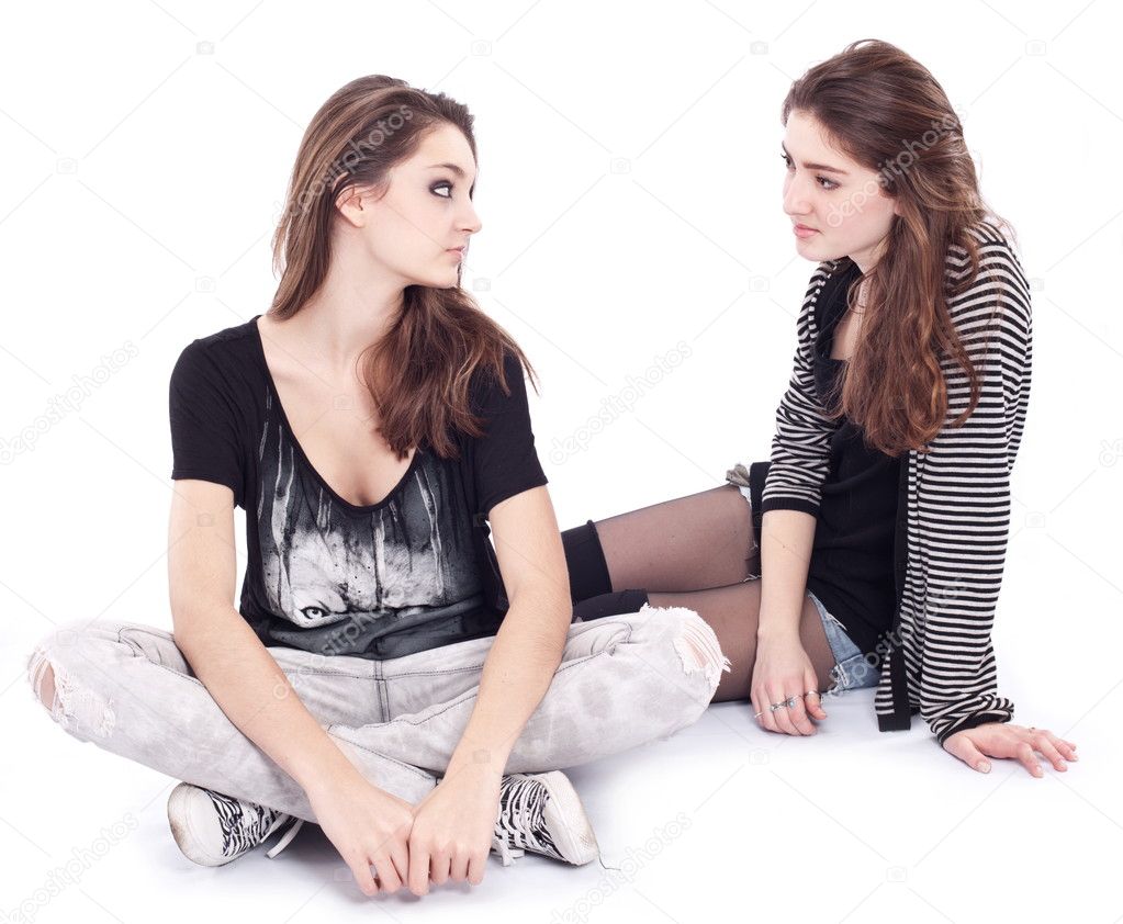 Two teen girlfriends on a white background.