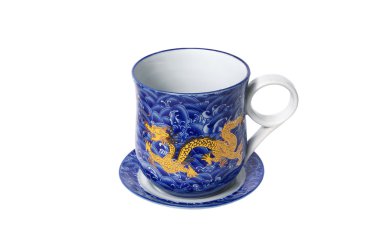 Porcelain saucer and cup with a dragon pattern isolated on white backgroun clipart
