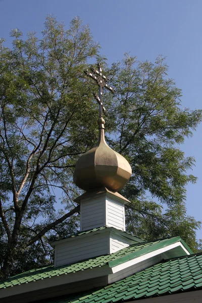 Cross and wooden church — Stok fotoğraf