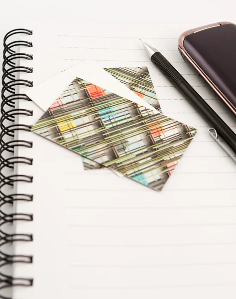 Pen and mobile phone and cards on notepad — Stock Photo, Image