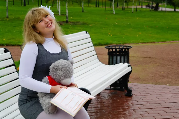 La colegiala sentada en un banco, Autumn Park, Moscú —  Fotos de Stock