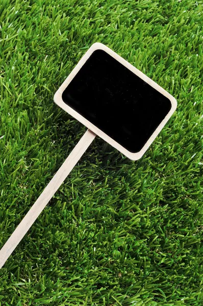 stock image Blank blackboard label on the grass