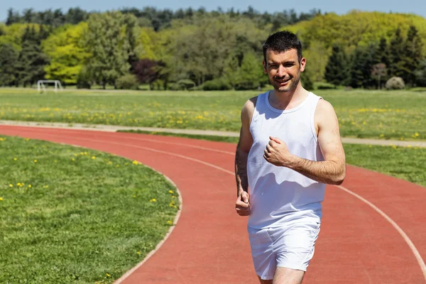 Man running on a track — Stock Photo, Image