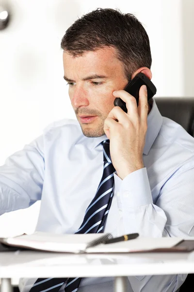 Ein Geschäftsmann am Telefon im Büro — Stockfoto