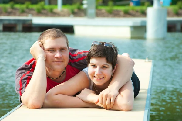 Young pair on harbor pier