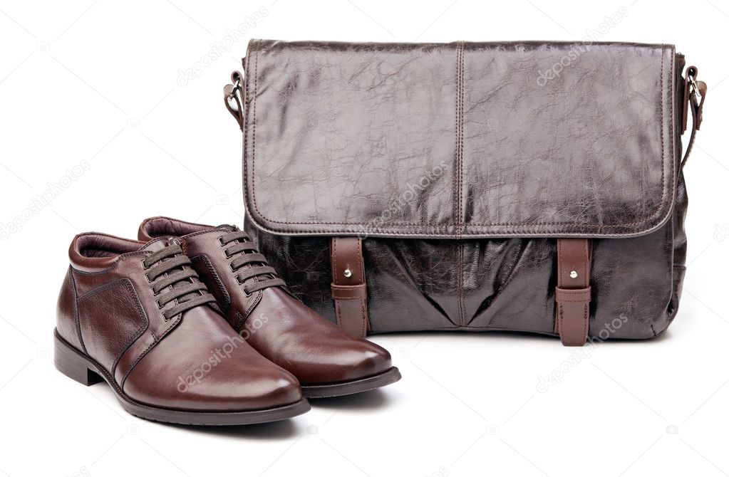 Pair of men boots and messenger bag over white