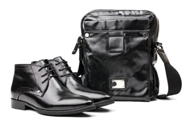 Pair of black men boots and messenger bag over white clipart