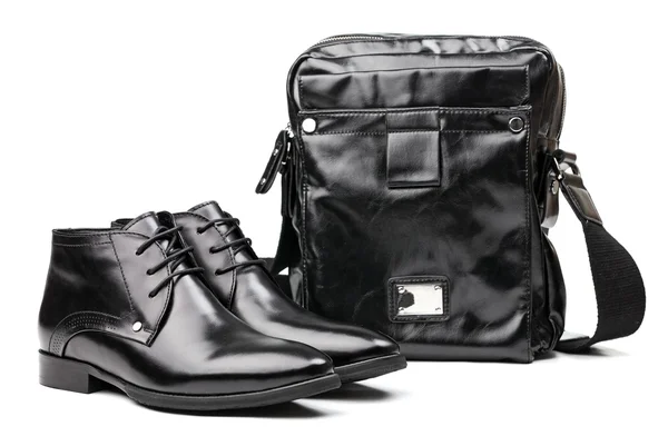 Pair of black men boots and messenger bag over white — Stock Photo, Image