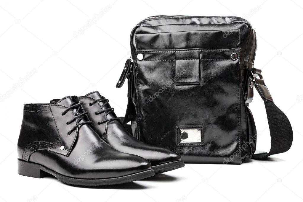 Pair of black men boots and messenger bag over white