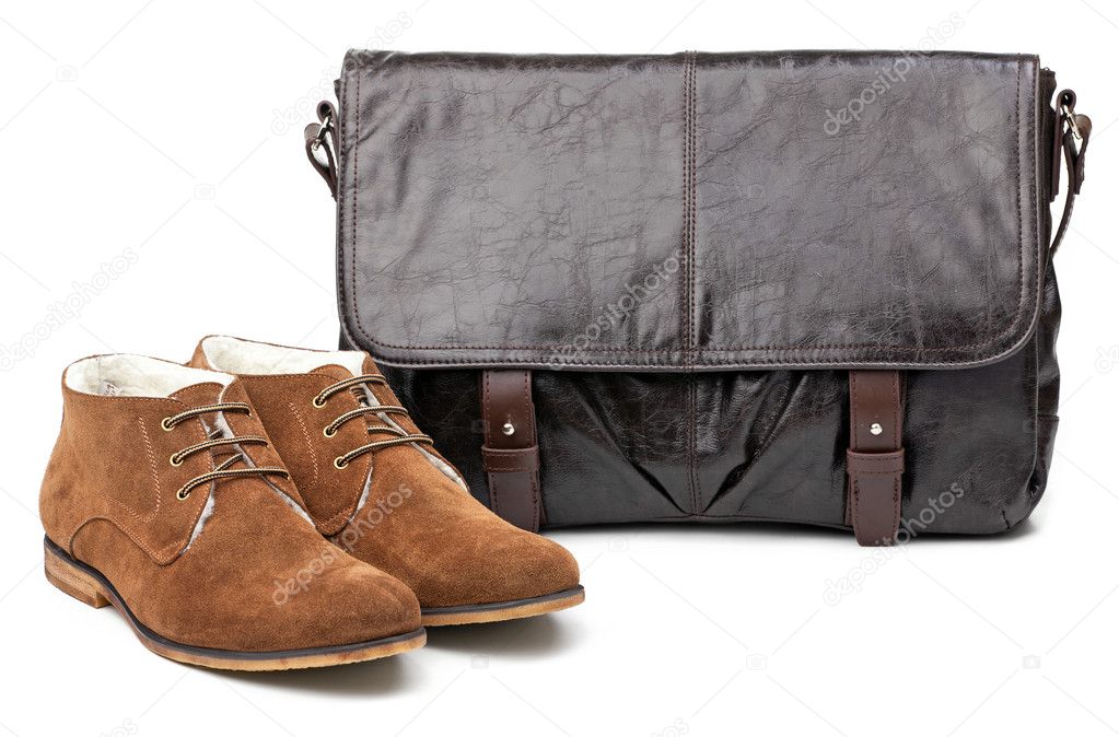 Pair of winter men boots and messenger bag over white