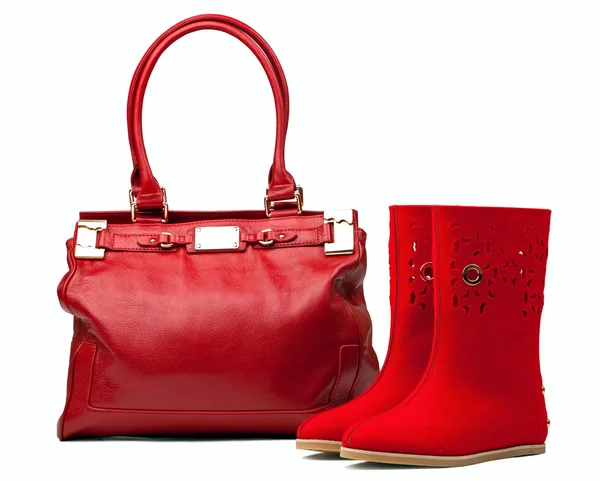 Pair of red felt boots and leather bag, with path — Stock Photo, Image
