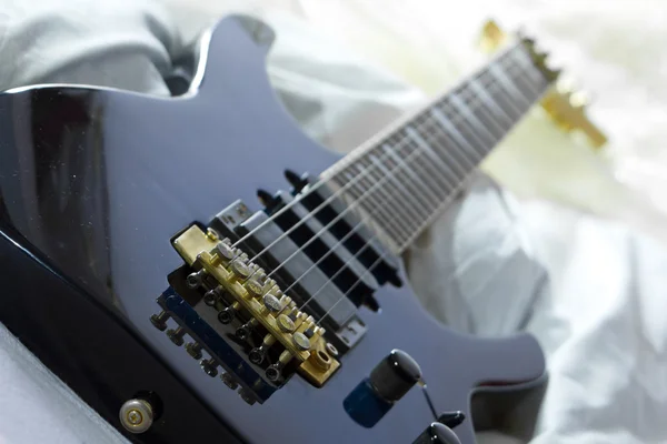 stock image Guitar in bed