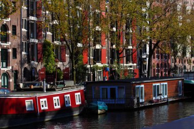 Quiet Amsterdam canal with house boats clipart