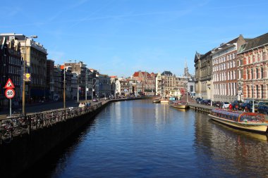 Quiet Amsterdam canal with house boats clipart