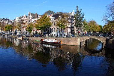 Quiet Amsterdam canal with house boats clipart