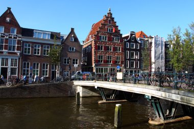 Quiet Amsterdam canal with house boats clipart