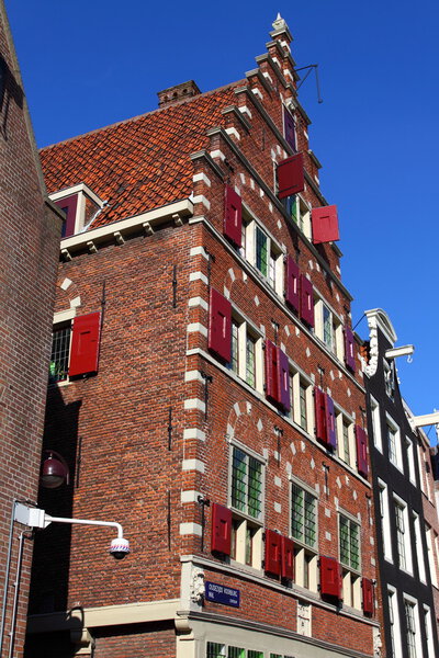 Typical Amsterdam houses over blue sky