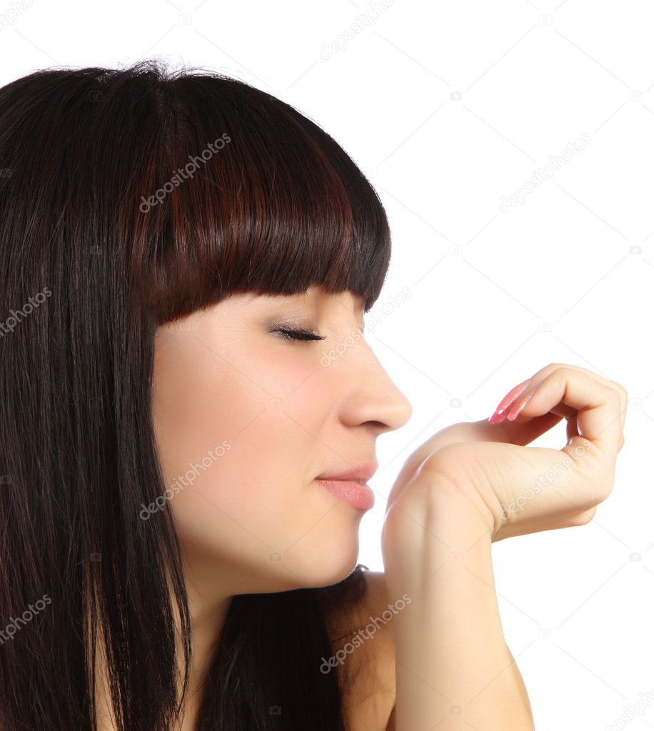 Young woman smelling perfume