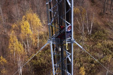 Tower climber inside the guyed tower clipart