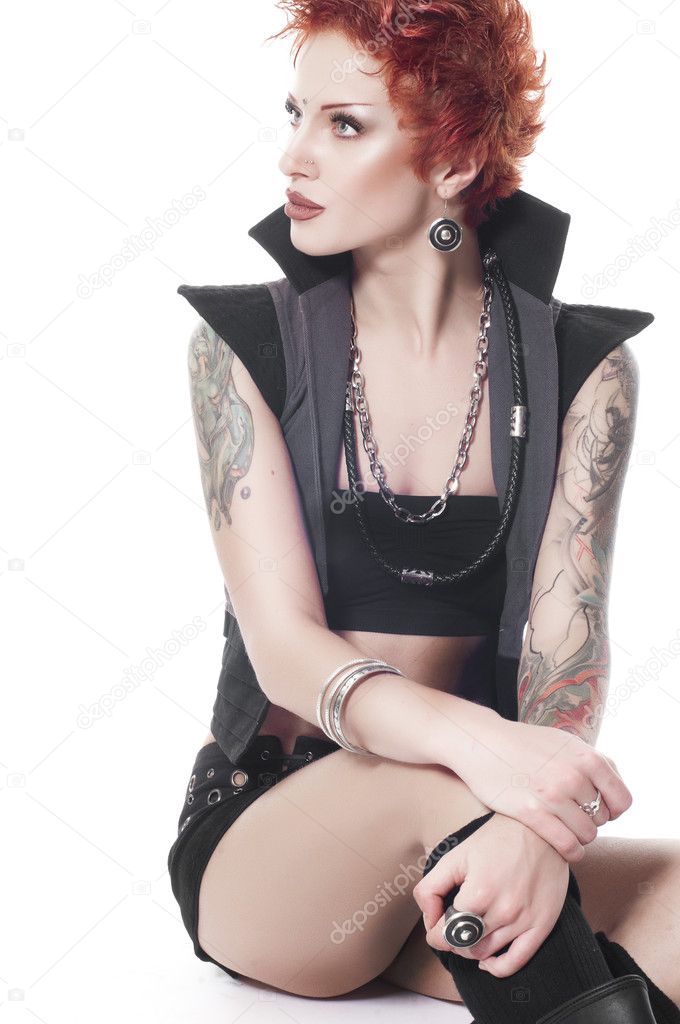 Sexual powerful woman with tattoos and short red hair isolated