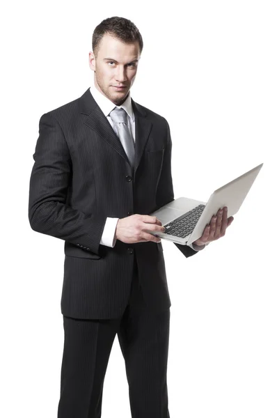 Bello giovane uomo d'affari in abito nero in possesso di notebook — Foto Stock