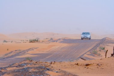 Car travelling across desert clipart