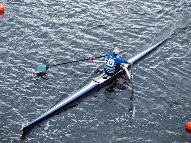 Man rowing in boat on water clipart