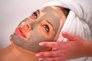 Spa clay mask on a woman's face clipart