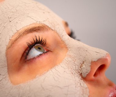 Spa clay mask on a woman's face clipart