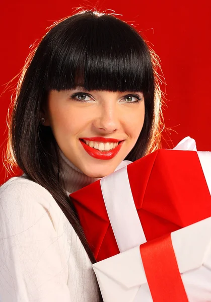 Portrait of a woman holding a few gifts — Stock Photo, Image