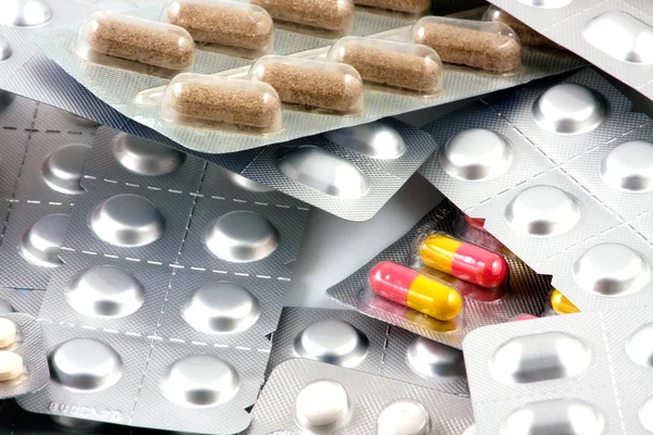 Pills of many shapes and colors grouped together — Stock Photo, Image